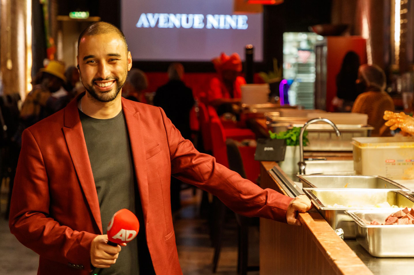 Miquil Tjon Kon Fat at Avenue Nine holding an AD microphone